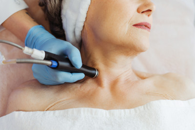 Skin treatment procedure on an elderly woman’s neck