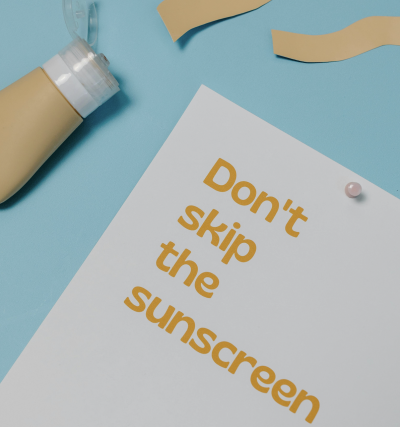 Sunscreen and sign with text “Don't skip the sunscreen”.